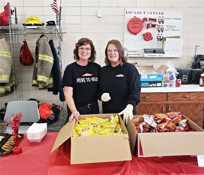 Two SERVPRO employees volunteering at the fire station