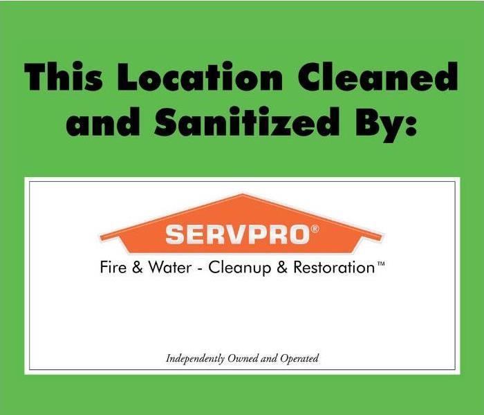 Green sign with the words, “This Location Cleaned and Sanitized by:” and the SERVPRO logo (orange house)