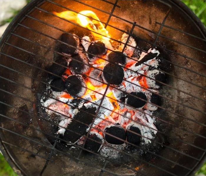 The top of a grill with burning coal.