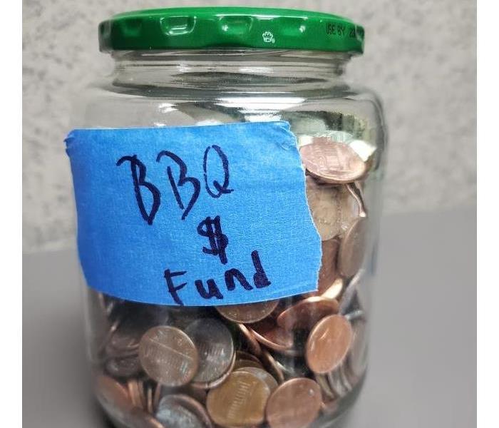 Picture of BBQ fund jar full of coins