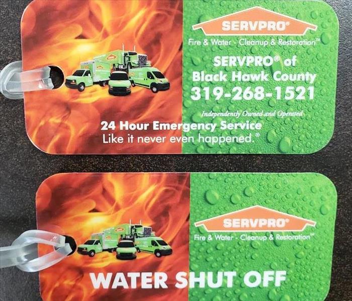 2 SERVPRO water shut off tags laying on a table