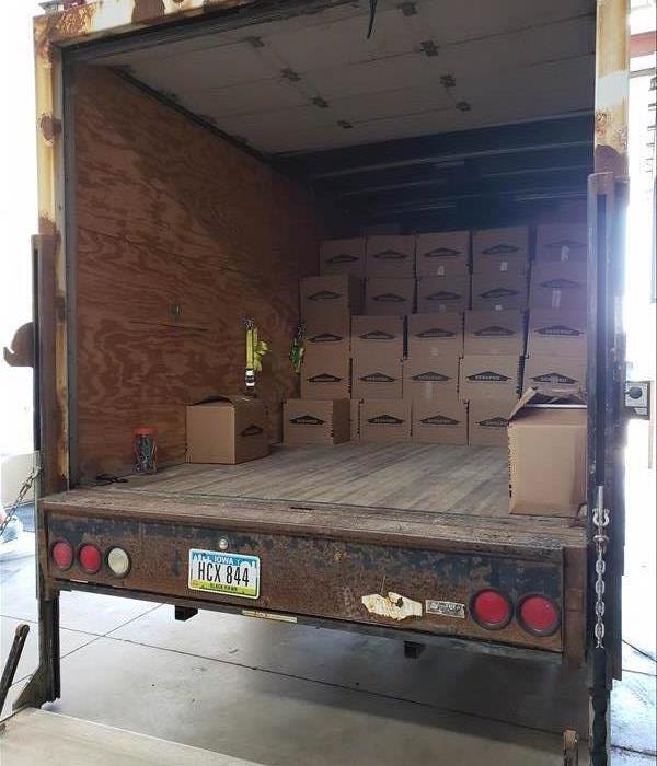 multiple boxes inside the trailer of a freight truck.