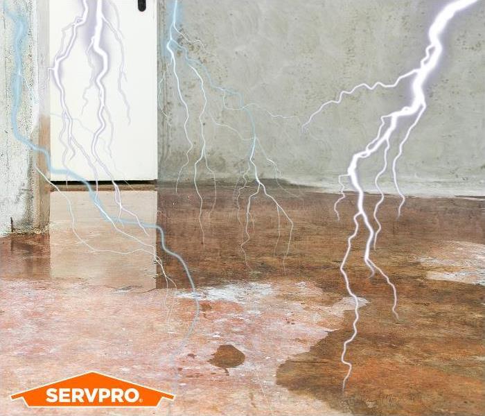 Lighting in water damaged basement with SERVPRO logo