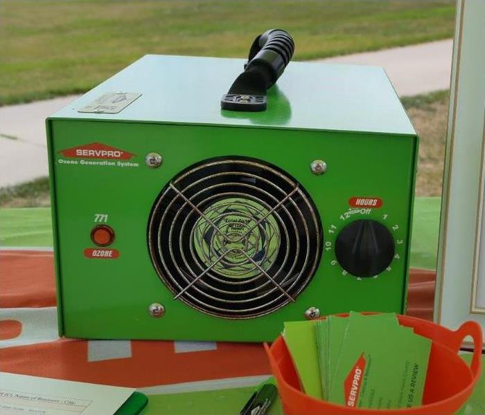 A small green ozone generator box with a fan vent and a dial.